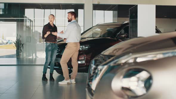 Middle Age Blond Charming Woman Smiling While Discussing Payment Rates for a New alt