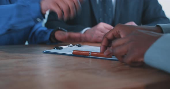 Close up of a busineswoman handing over a contract to a businessman alt