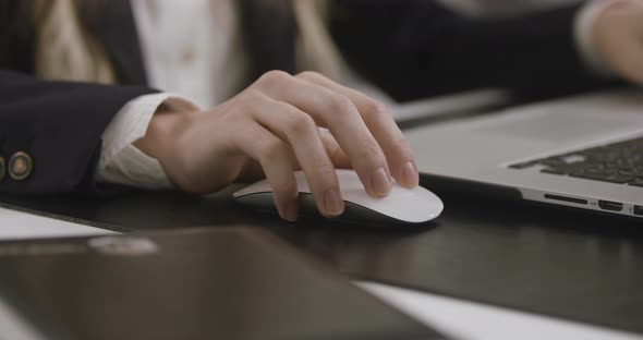 Woman's Hand Clicking Computer's Mouse