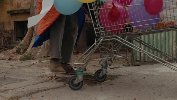 Homeless Man Out on the Streets with His Belongings in a Trolley alt