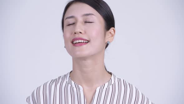 Face of Happy Beautiful Asian Businesswoman Relaxing with Eyes Closed alt