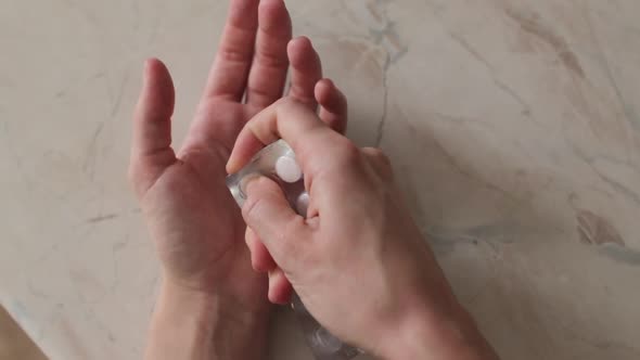 Pills Out Of Blister Pack in a Woman's Hand Close Up