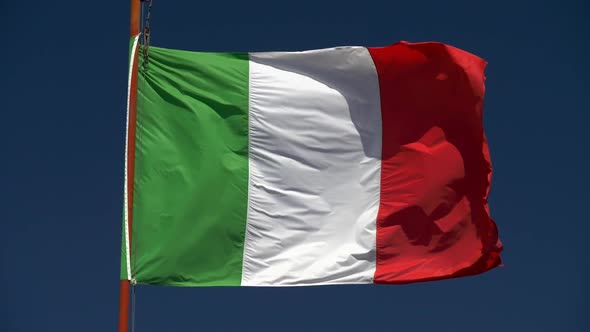 Slow Motion Shot of Waving Flag of Italy on Blue Sky Background alt