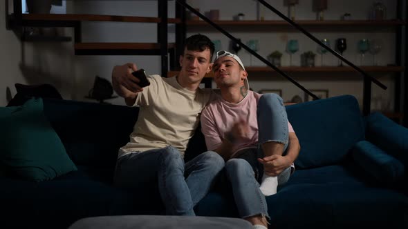 Joyful Confident LGBTQ Couple Taking Selfie on Smartphone Sitting in Cozy Living Room at Home alt