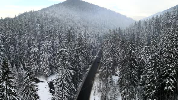 Aerial View of Snowed Winter Road in Carpathian Mountains alt