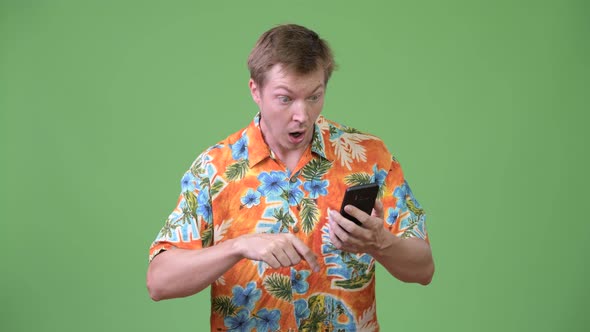 Young Handsome Tourist Man Using Phone and Giving Thumbs Up alt