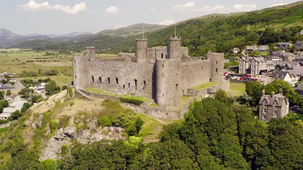 Harlech castle in North Wales, Gwynedd, UK, shot by drone to show proximity of the castle against th alt