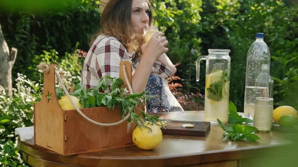 Woman Enjoying Summer Drinking Lemonade Cocktail alt