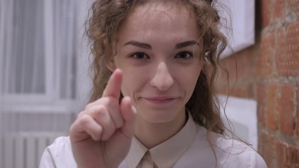 Serious Female Pointing at Camera with Finger alt