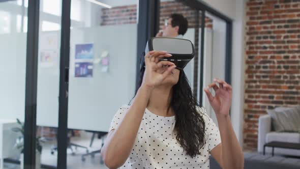 Woman using VR headset at office alt