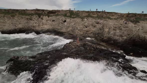 Girls are Photographed on a Rock Near the Sea alt