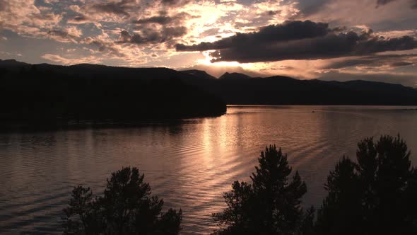 Flying over tree tops to lake alt