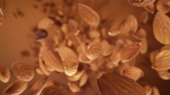 Super Slow Motion Detail Shot of Almonds Flying Towards Camera at 1000 Fps alt