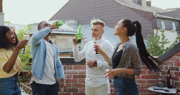 Mixed Race People Having Fun Together During Friends Party on the Terrace alt