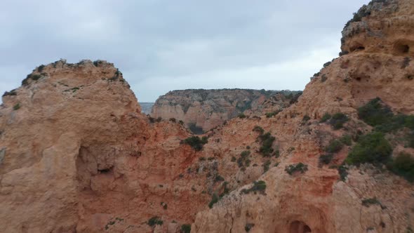 Aerial View of Lagos Astonishing Rocky Cliff Coastline Drone Flying Forward Above Coast Reveal alt