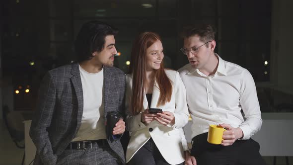 A Team of Young Colleagues is Talking Sharing Ideas During a Break Late at Night in the Conference