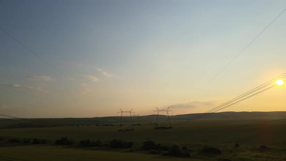 High Voltage Towers with Electric Power Lines at Sunset alt