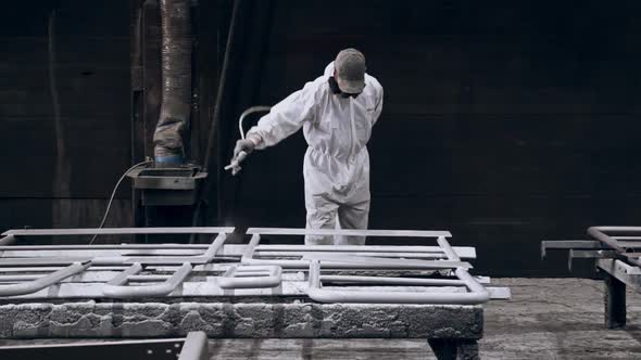 Painter varnishes in a factory