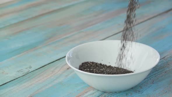 Chia Seeds are Poured Into a Bowl