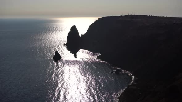 Aerial View From Above on Calm Azure Sea and Volcanic Rocky Shores alt