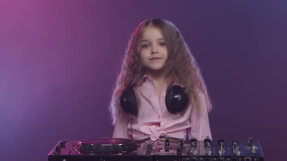 Music on Dj Console Is Performed By Little Girl Musician alt