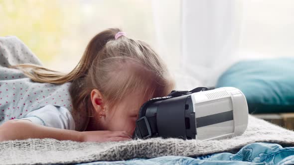 Cute Girl Watching Video in VR Goggles