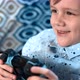 Young Boy Plays Video Game with Joystick and Showing Lots of Emotions - VideoHive Item for Sale