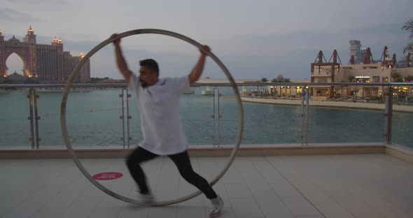 Atlantis Hotel in the Background of a Man Doing Wheel Gymnastics alt