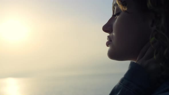 Relaxed Girl Dreaming on Beach at Sunrise alt
