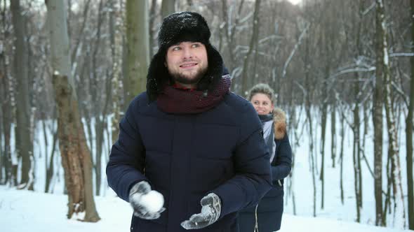 Pair Having a Snowball Fight alt