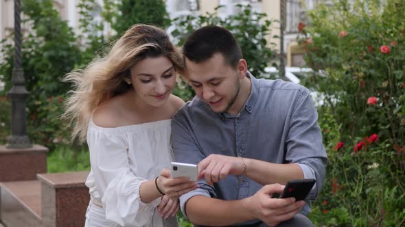 Couple Looks Into Phone