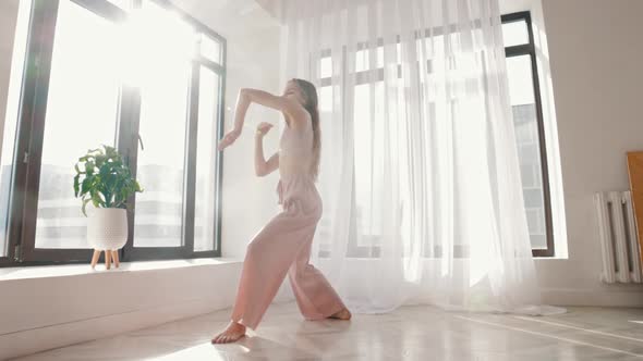 Street Dancing  Young Slim Woman Dances in White Spacious Room alt