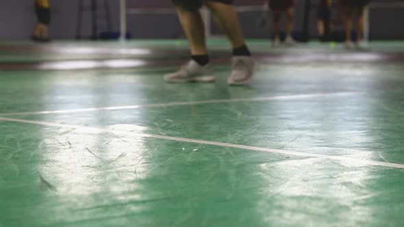 Blurred of the badminton courts with players competing in indoor.