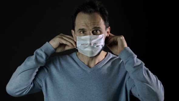 Man Puts on Medical Mask, Inscription nCoV-2019. Coronavirus Outbreak in Europe alt