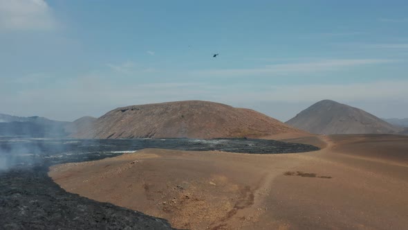 Helicopter Observing Above Volcanic Landscape After Eruption alt