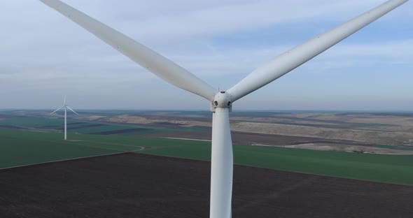 Wind Turbine Blades Spinning in Close up, Aerial Pull Back View alt