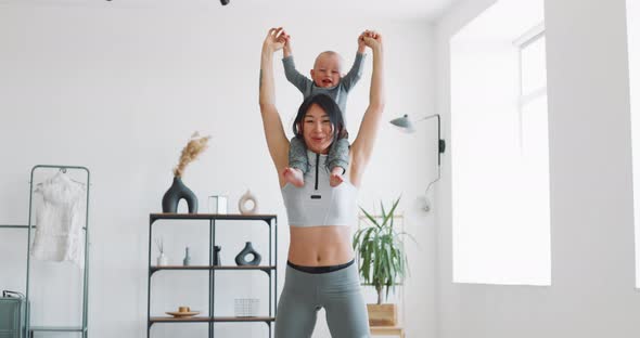 Mom and Child Do Fitness at Home During Isolation alt