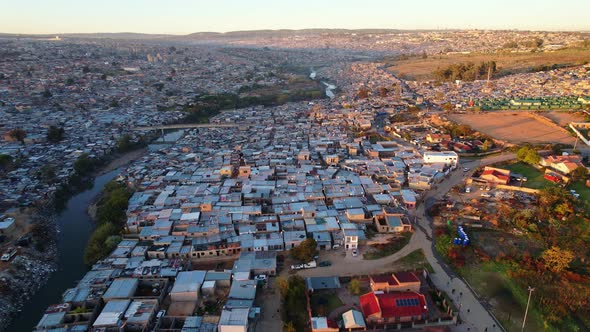 Drone footage capturing the Alexandria township in Johannesburg South Africa. Corrugated tin roof to alt