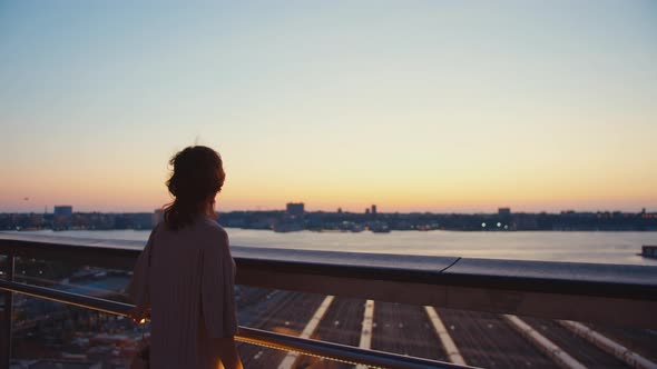 Young girl on the roof at sunset alt