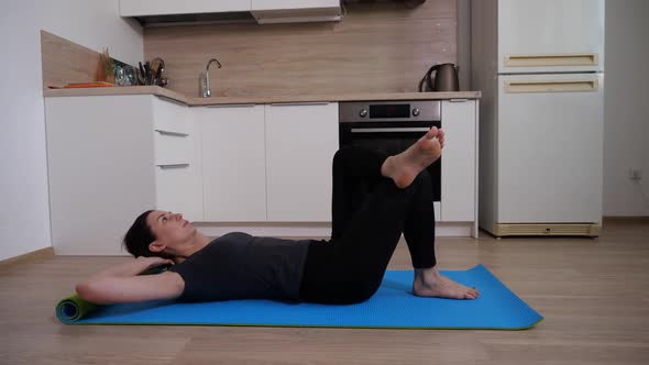 A Girl Does an Exercise to Strengthen the Abdominal Muscles Lifts the Torso