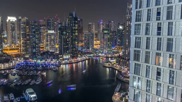 Luxury Dubai Marina Canal with Passing Boats and Promenade Night Timelapse Dubai United Arab alt