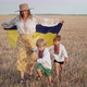 Ukrainian Patriot Boys and Mother Running Together with National Flag on Open Area Wheat Field After - VideoHive Item for Sale