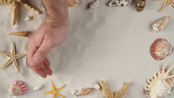 Man's Hand is Clearing the Sand Demonstrating Advertising Area Workspace Mock Up alt