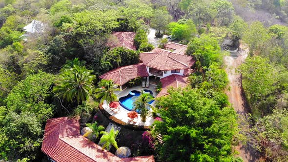 Aerial panning right drone shot of Los Altos de Eros in Tamarindo, Costa Rica. alt