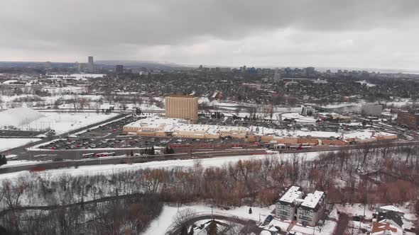 Aerial drone view of bus station in Barrhaven Ottawa Ontario Canada in winter on grey day alt