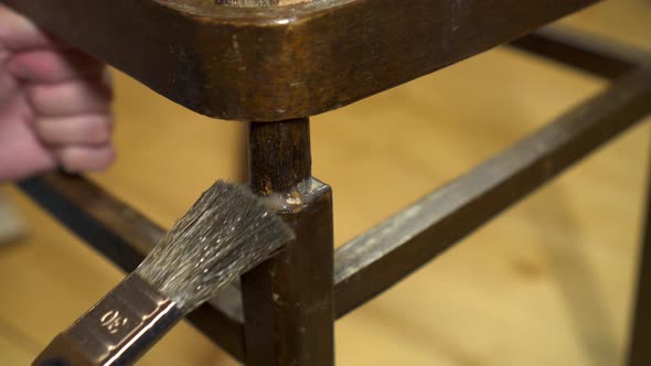 Applying Glue with a Brush on an Old Wood Lacquered Chair