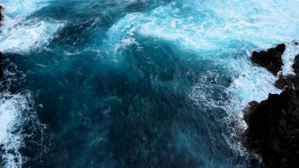 Waves crashing Into Cliffs Near the Shores of Porto Moniz, Madeira island, Portugal alt