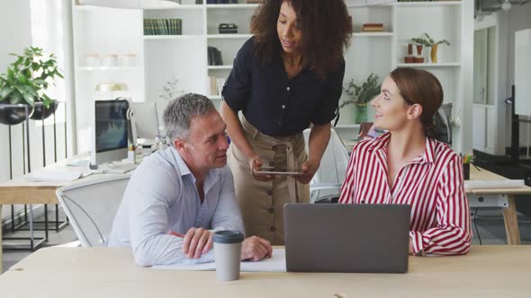 Colleagues discussing about something on the computer alt