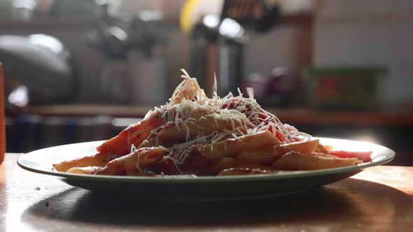 Sprinkle Pasta with Grated Cheese in Slow Motion alt