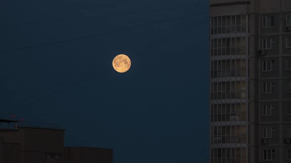 Full Moon Hiding Behind the Highrise Building on a Sunrise